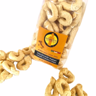 Top view of a bag of Giannetti Artisans plain Italian taralli crackers on a white background