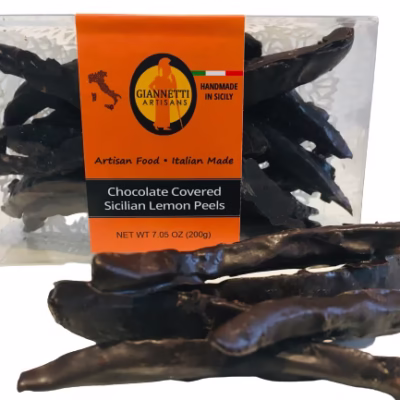 Clear box of Giannetti Artisans chocolate lemon peels with a few lemon peels on the side of the box for demonstrative purposes