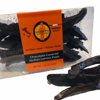 Side angle of a 7.05 oz box of Giannetti Artisans chocolate lemon peels with a few peels on the side of the box for demonstrative purposes