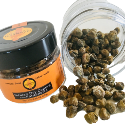 Top view of 2 jars of Giannetti Artisans Dry Capers with one of the jars tipped over displaying the capers pouring out
